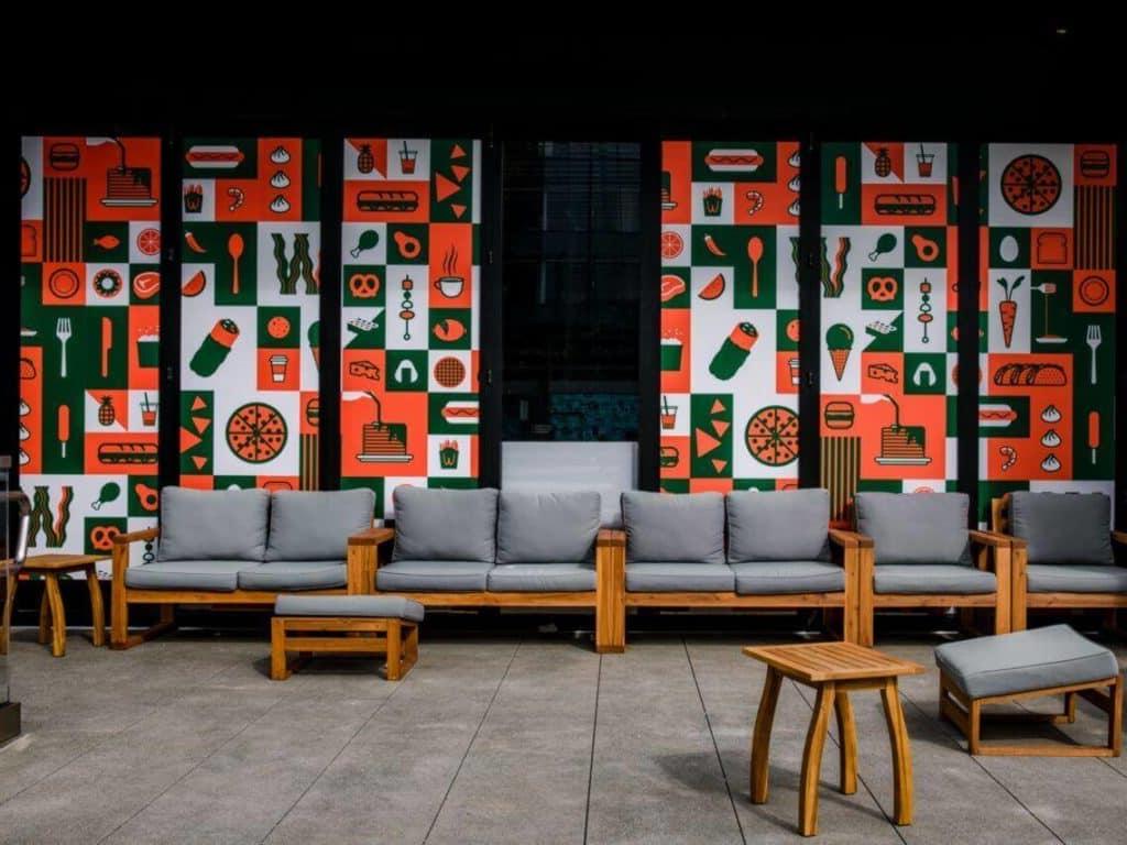 Colorful art displays hanging behind a line of chairs inside a medical practice waiting room